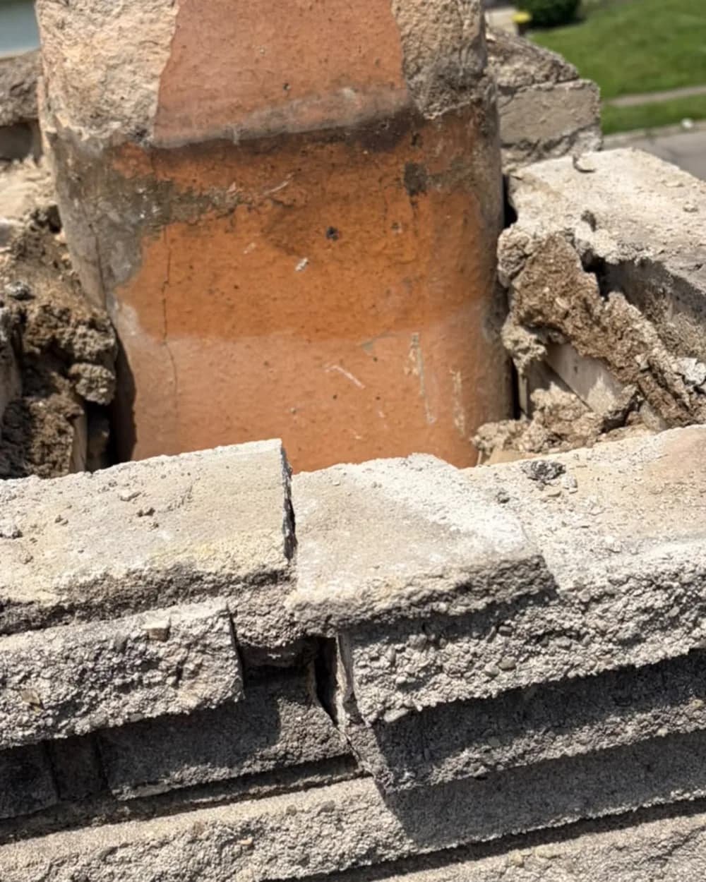 Close view of the flue exposed while the old crown material is removed