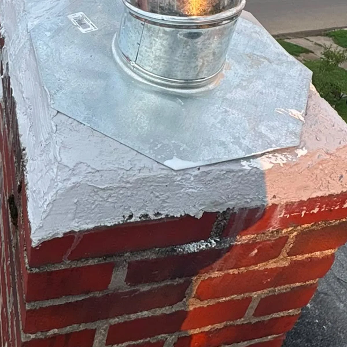 After: A broken chimney crown beneath an old metal hood, and the same brick stack with a rebuilt crown and two capped metal flues