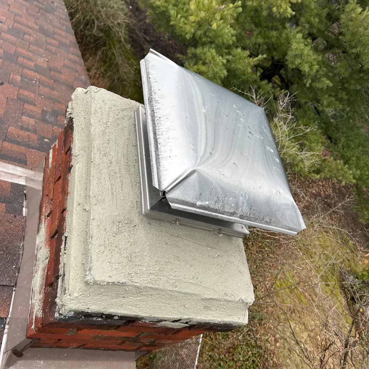 After: A chimney crown cracked and separated above deteriorated brick, and the same crown rebuilt around a screened metal cap