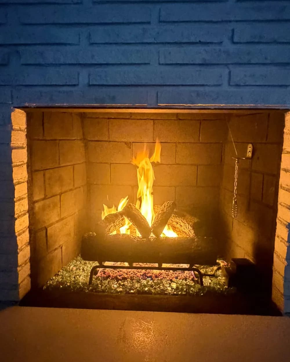Close view of the completed fireplace with the fire lit
