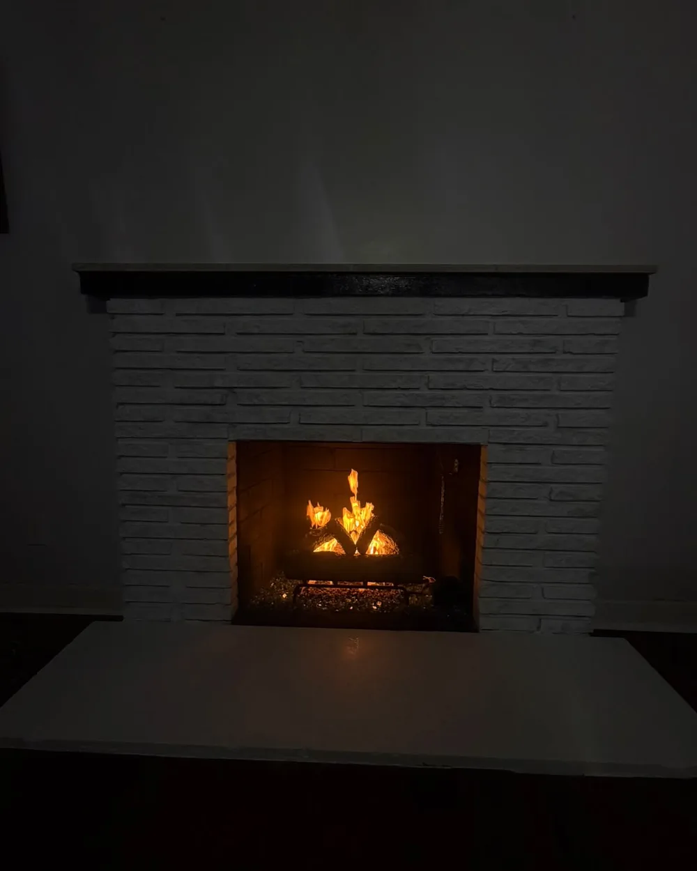 Evening view of the completed fireplace with the fire lit