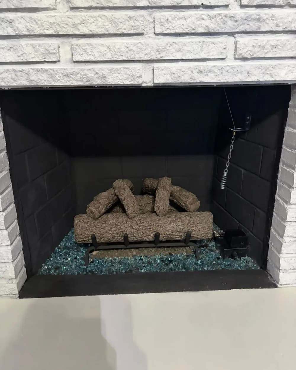 Close view of the arranged log set in the finished dark firebox