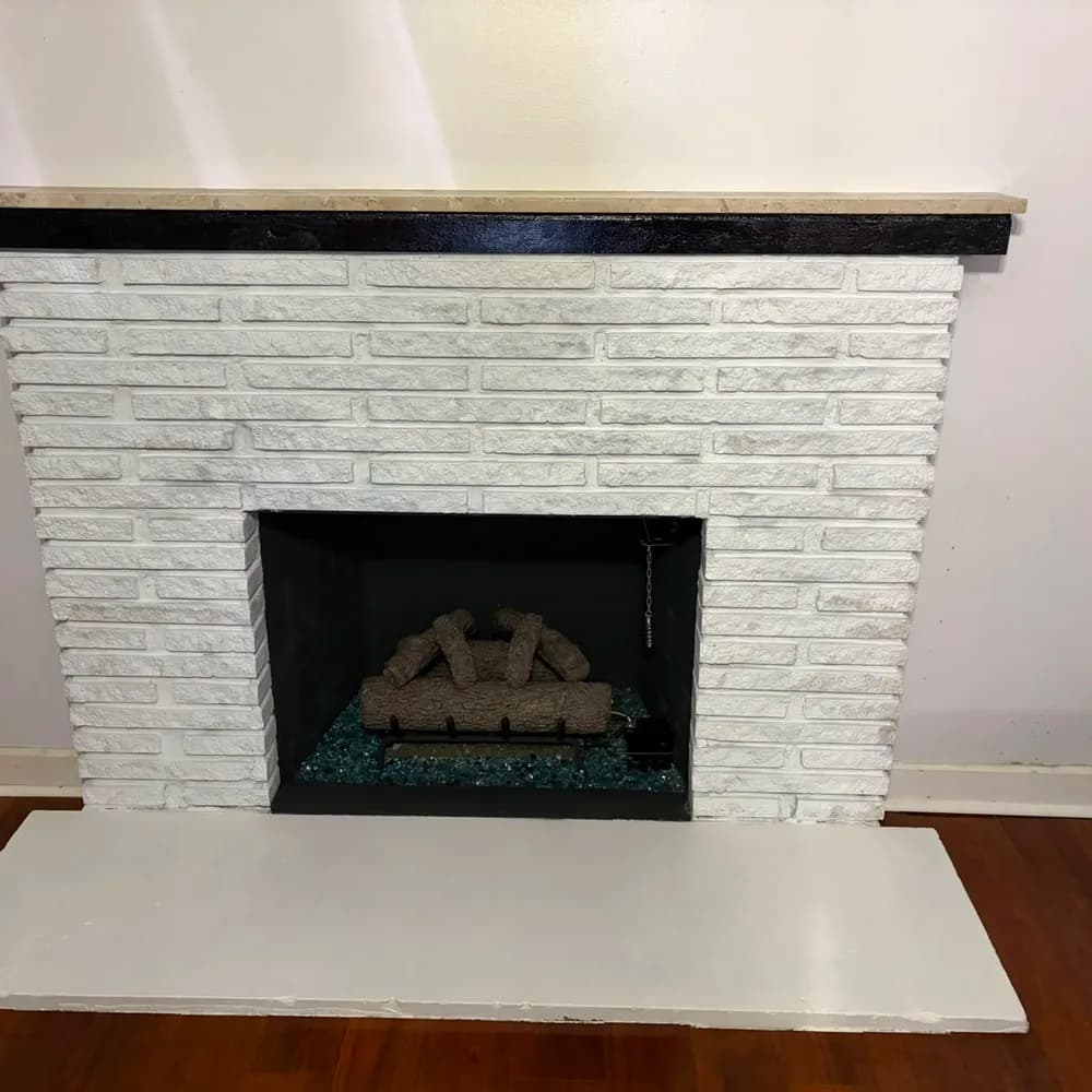 After: A cleared fireplace opening with the firebox exposed, and the same fireplace finished with an arranged log set