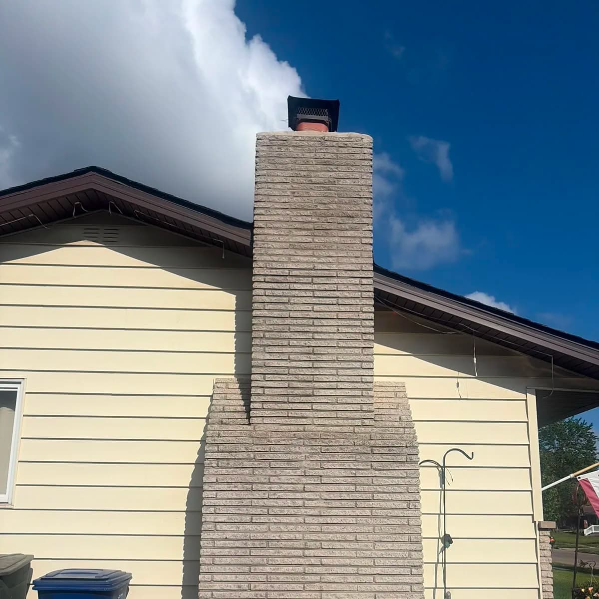 The same tall exterior chimney with continuous finished masonry joints